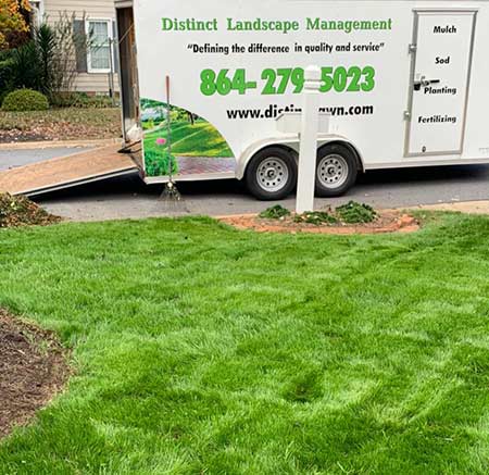 Distinct landscape truck parked in front of mowed grass