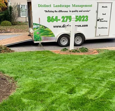 Distinct landscape truck parked in front of mowed grass